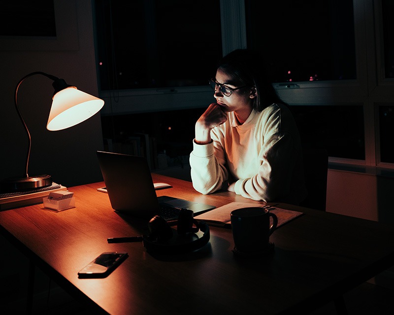 Woman at a laptop having late night therapy in Texas