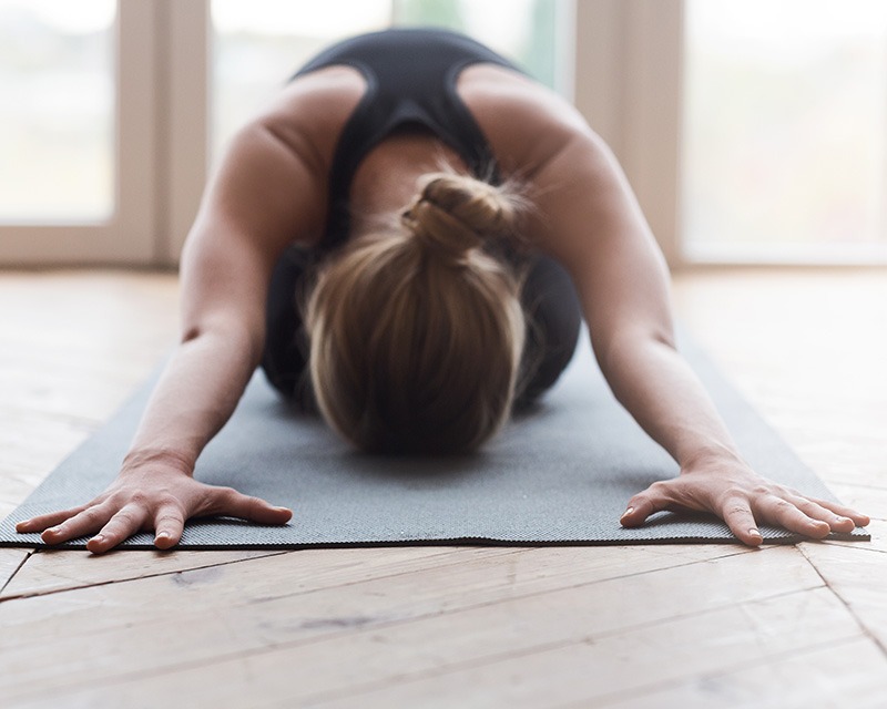 Woman practicing yoga. Wellness services in Houston