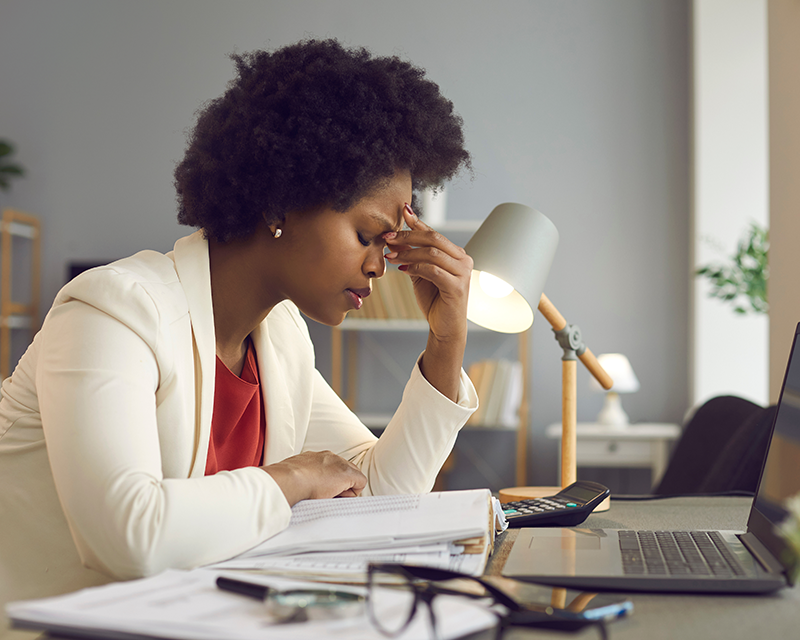 Woman feeling burnout while working; therapy for burnout in Texas